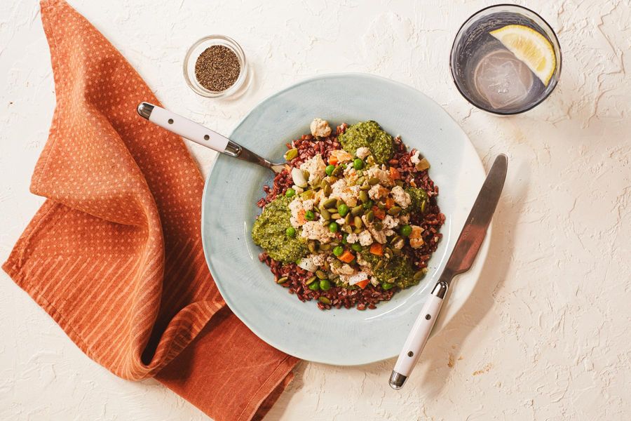 Chicken mole verde with red rice, sweet peas, and pumpkin seeds