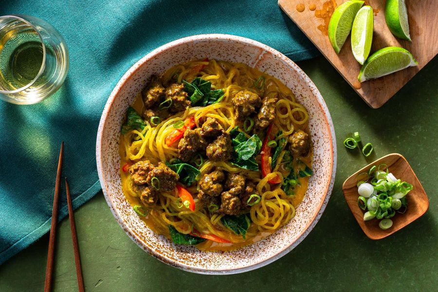 Curry noodle bowls with broccoli leaves and bell pepper
