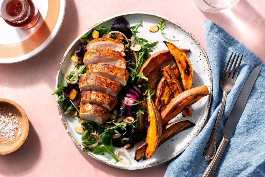 Paprika-rubbed chicken with almond picada salad and sweet potato fries