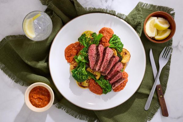 Steaks and romesco with baby broccoli, squash, and almonds