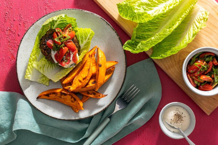 Lettuce-wrapped burgers with tomato relish and sweet potato fries