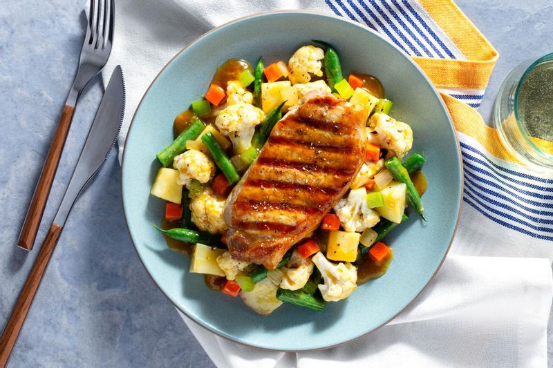 Grilled Pork Chop with Curry Sauce over Roasted Apples and Cauliflower