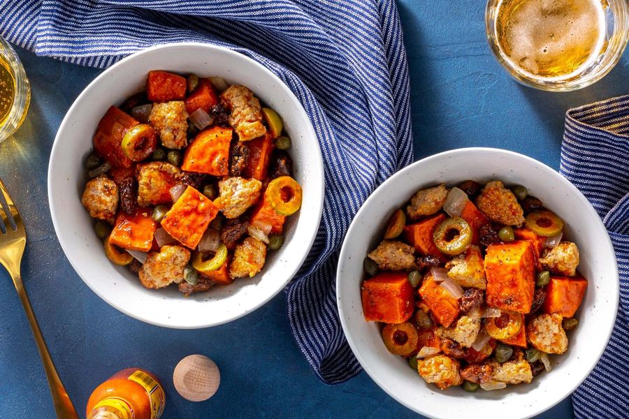 Picadillo stew with capers and raisins over roasted sweet potato