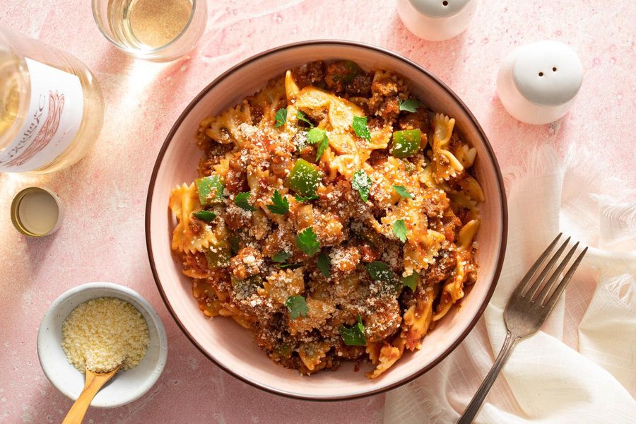 American chop suey with ground beef and bow tie pasta in tomato sauce