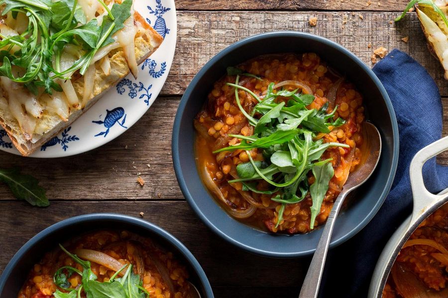 Smoky red lentil stew and cheese toasts with caramelized onions