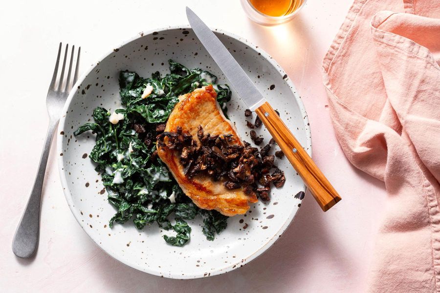 Pork chops with sautéed porcini mushrooms and kale