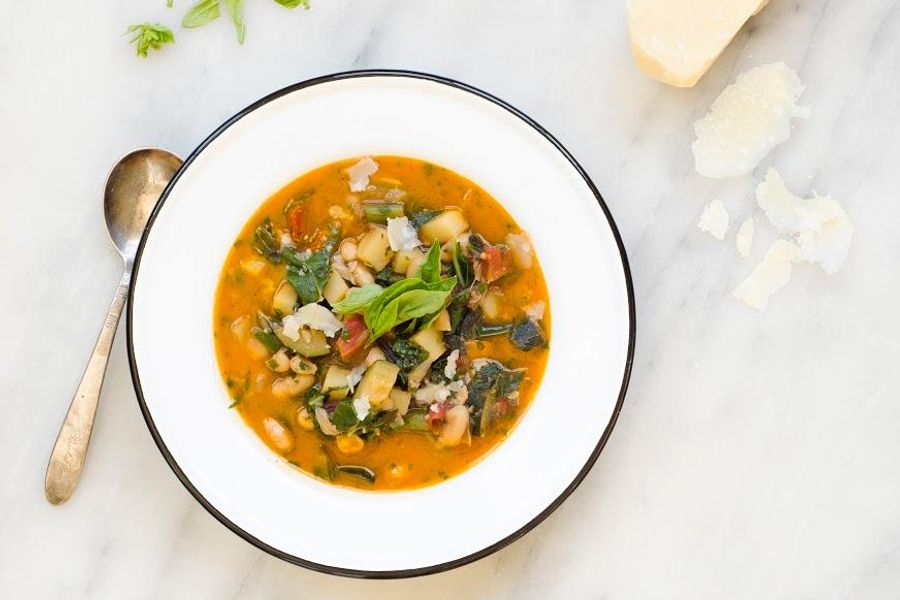 Spring vegetable minestrone soup with basil and pecorino