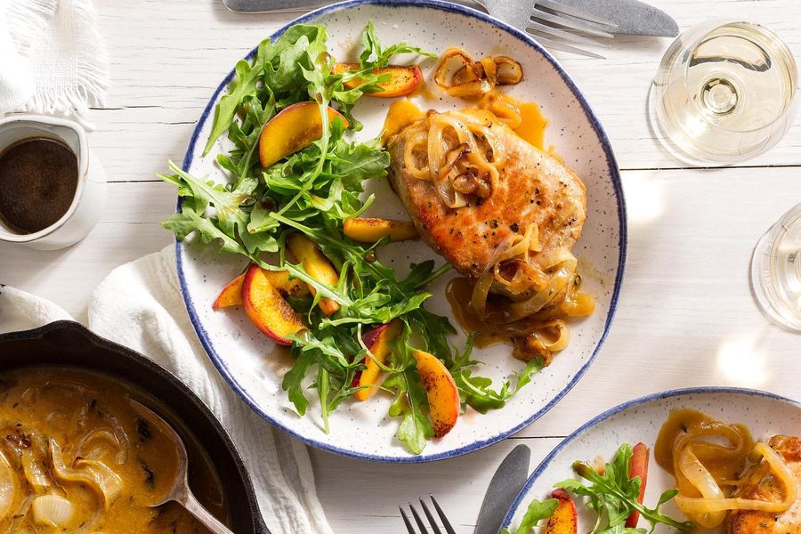 One-pan pork chops and gravy with arugula and sliced peaches