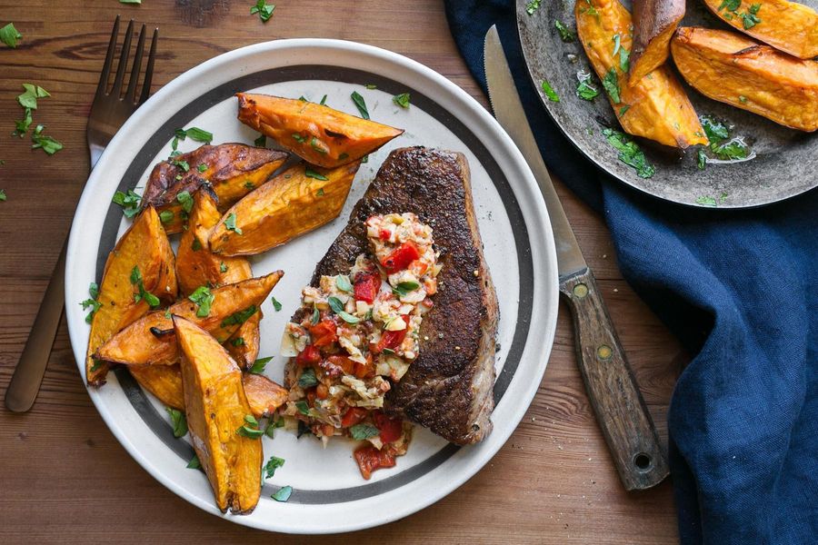 Steaks with artichoke-red pepper tapenade and sweet potato fries