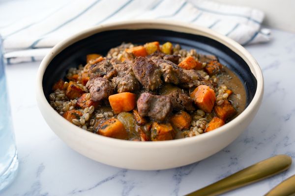 Slow cooked beef and roasted root vegetables bowl