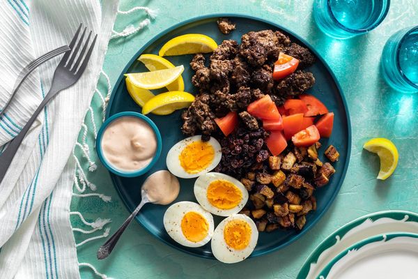 Mediterranean meze platter with lamb, eggplant, and hard-cooked eggs