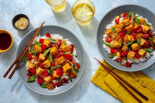 Sweet and sour tofu with water chestnuts, snap peas, and steamed rice