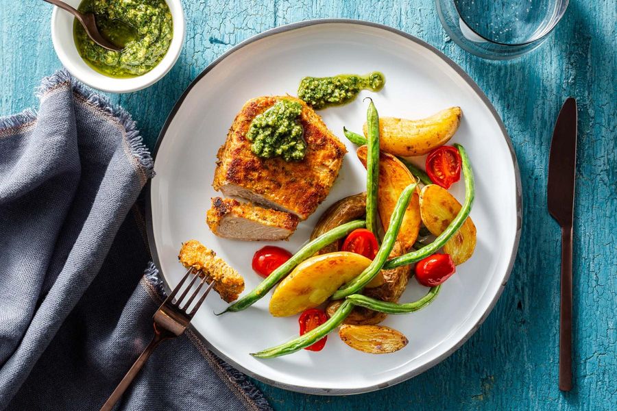 Roasted garlic-herb pork chops with basil pesto and green beans