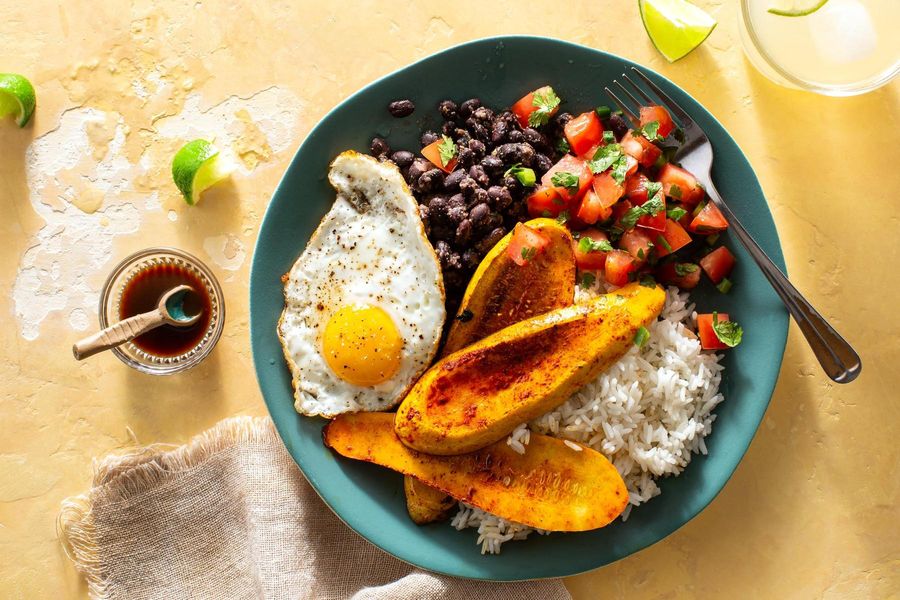 Costa Rican casado with fried eggs, black beans, and two salsas