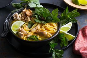 Thai curried chicken noodle soup with baby greens