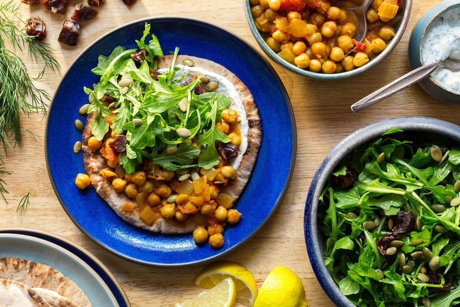 Pita flatbreads with curried chickpeas and arugula-date salad image