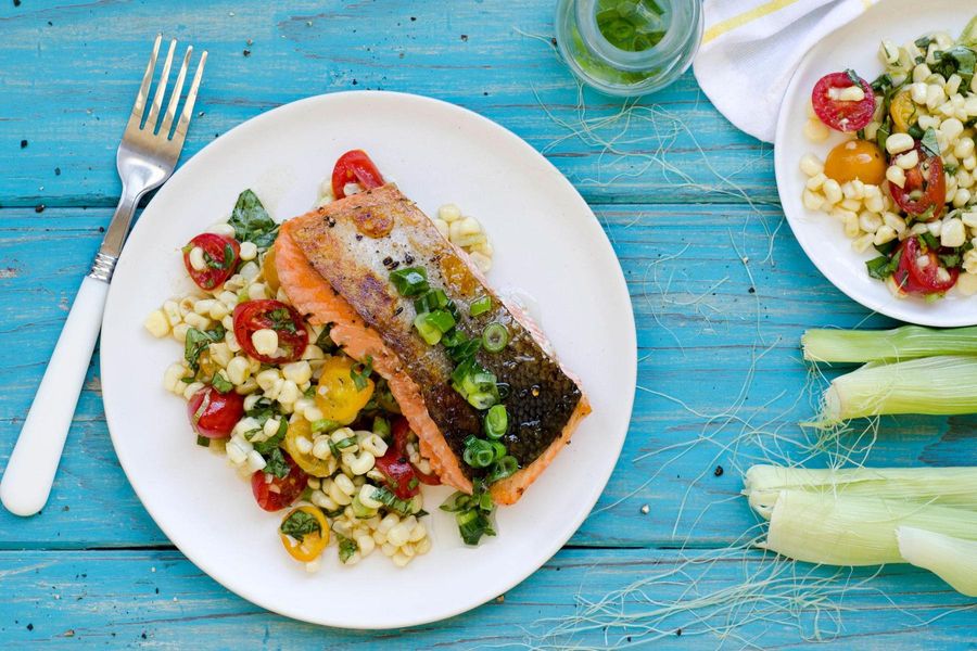 Seared salmon with corn, cherry tomato and basil salad