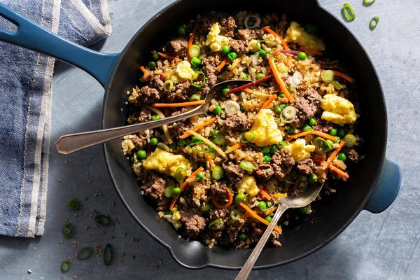 Pork fried cauliflower “rice” with carrots, peas, and scallions