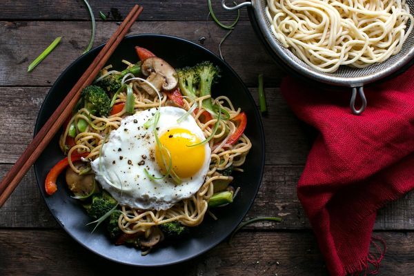 Stir-fried egg noodles with sesame sauce and a fried egg