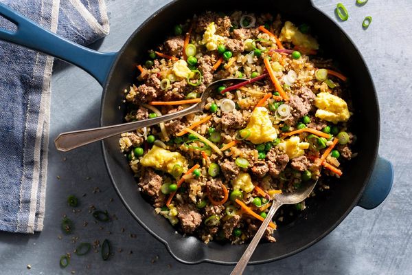 Pork fried cauliflower “rice” with carrots, peas, and scallions