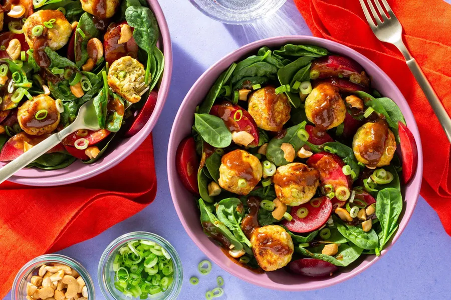 Lemongrass chicken meatballs with spinach-plum salad and cashews