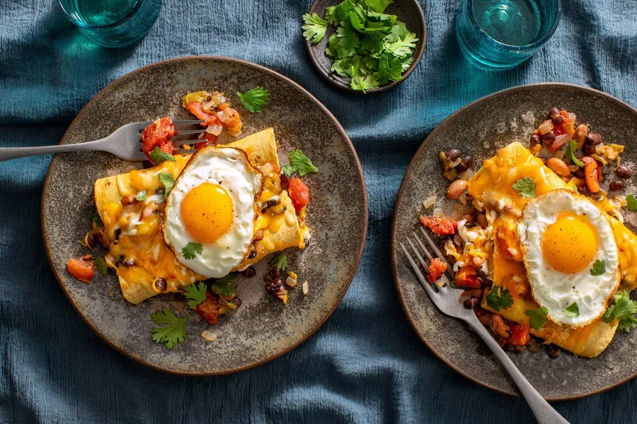 Two-bean enchiladas with green chiles and fried eggs