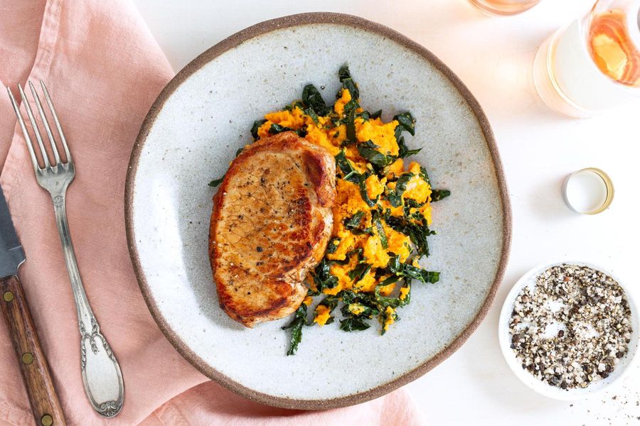 Pork chops with coriander-spiced sweet potato, kale, and roasted garlic