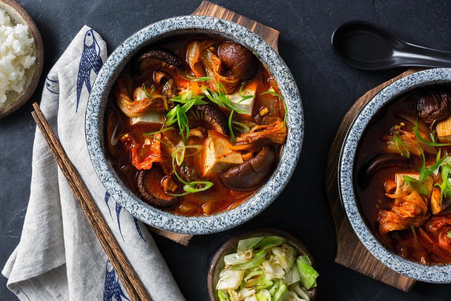 Korean kimchi stew with tofu, shiitake mushrooms, and steamed rice