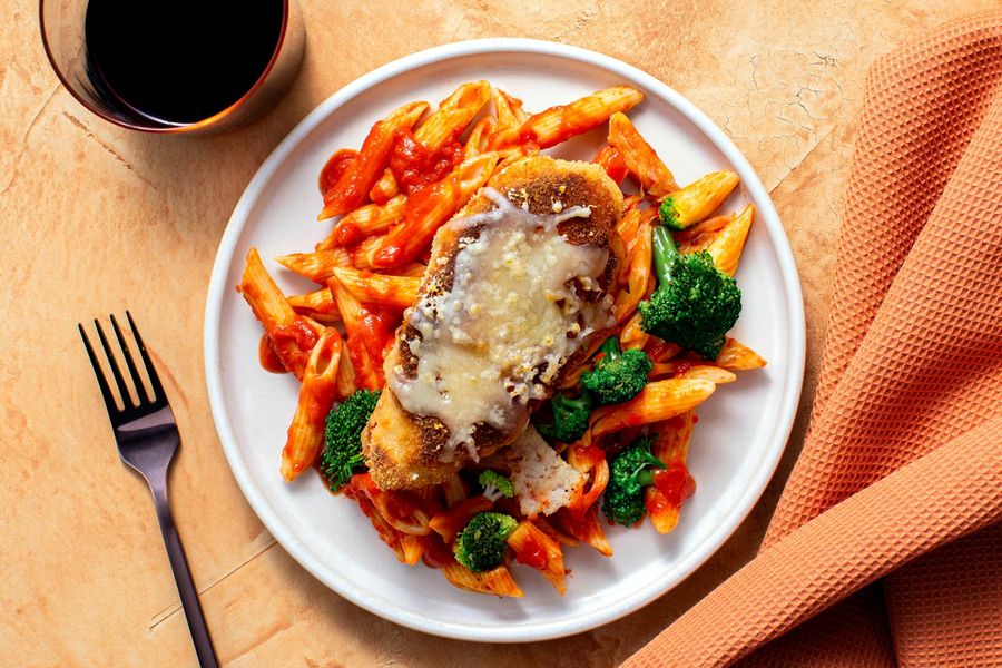 Breaded chicken Parmesan over penne with herbed marinara and broccoli