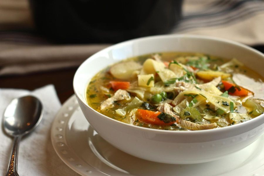 Chicken soup with egg noodles and petite peas