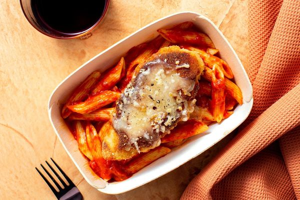 Chicken Parmesan with basil marinara over penne