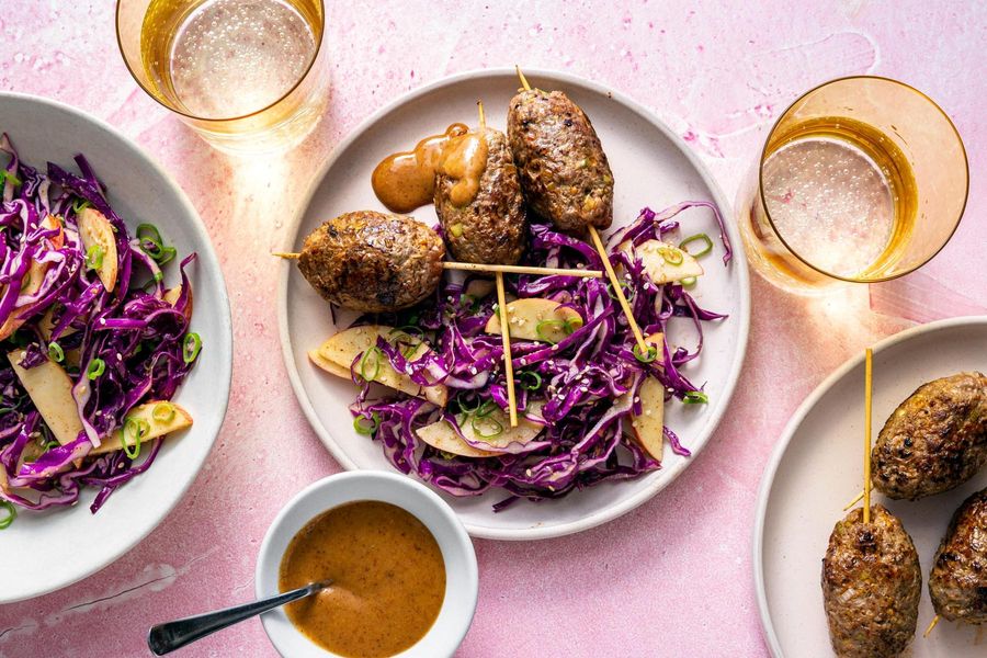 Ginger-scallion beef skewers with apple and cabbage slaw
