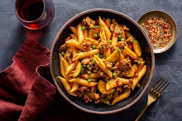 Turkey Bolognese with penne rigate, zucchini, and peas