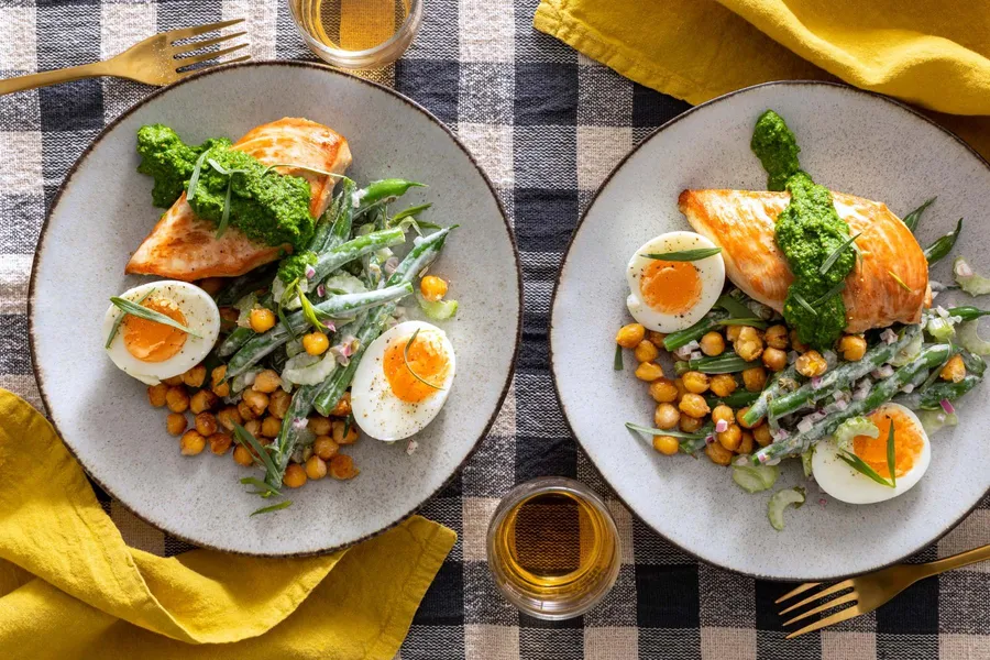 Chicken breasts over crispy chickpeas with green bean salad and pesto