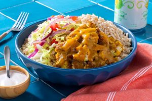 Gyro-spiced chicken bowl with brown rice, fresh slaw, and yogurt sauce