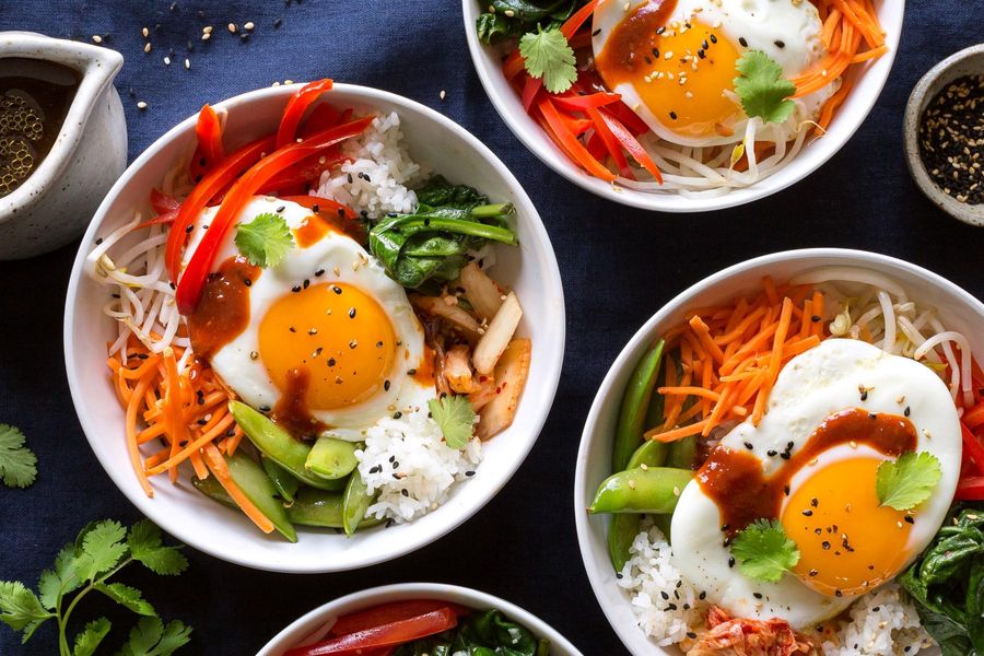 Bibimbap with snap peas, carrots, and fried eggs