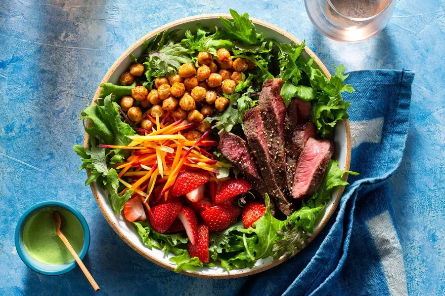 Steak salad with strawberries and spiced chickpeas Available with sirloin, rib-eyes, New York strips, or filet mignons