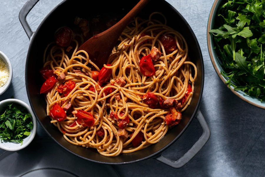 Fresh spaghetti with pancetta-tomato sauce and arugula salad