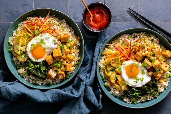 Korean beef bibimbap with spinach, squash, and fried eggs