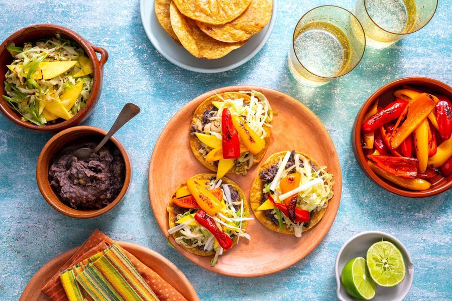 Spicy Jamaican black bean tostadas with sweet peppers and mango slaw
