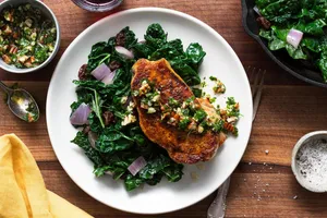 Southern French–style pork with garlicky pecan aillade and braised kale