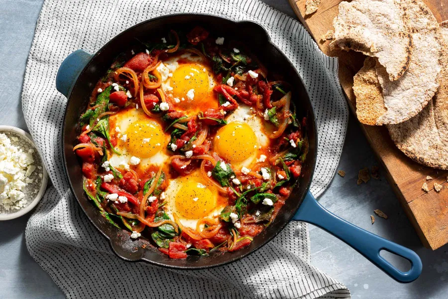 Shakshuka with spinach, feta, and toasted pita