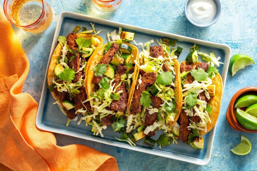 Steak tacos with zucchini-scallion salsa, cabbage slaw, and lime yogurt