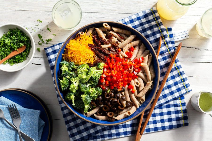 Fresh penne pasta salad with broccoli and sun-dried tomatoes