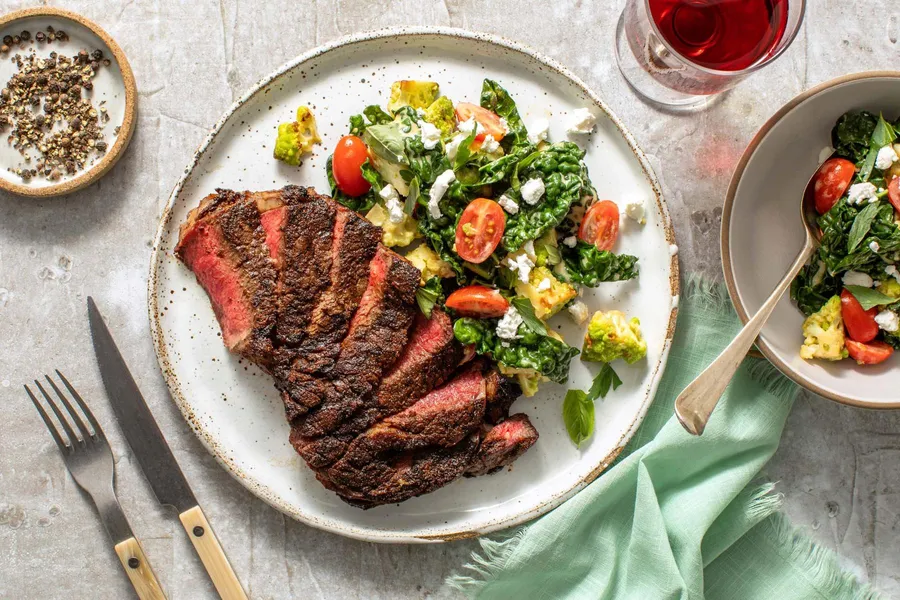 Black Angus rib-eyes with warm kale, romanesco, and goat cheese salad