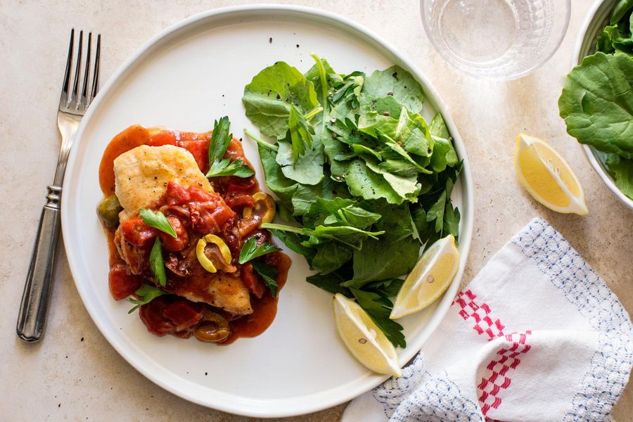 Mediterranean chicken with tomatoes, olives, and kale salad