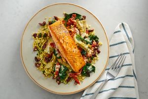 Salmon with sun-dried tomatoes, artichokes, and pearled couscous