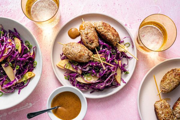 Ginger-scallion beef skewers with apple and cabbage slaw