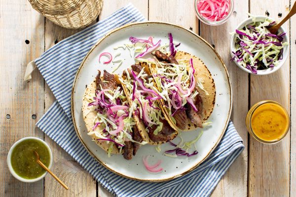 Mojo pork tacos with pickled onions and salsa verde