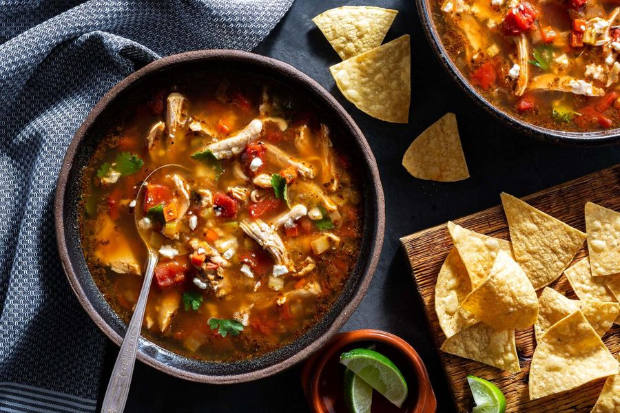 Chicken tortilla soup with queso fresco and lime